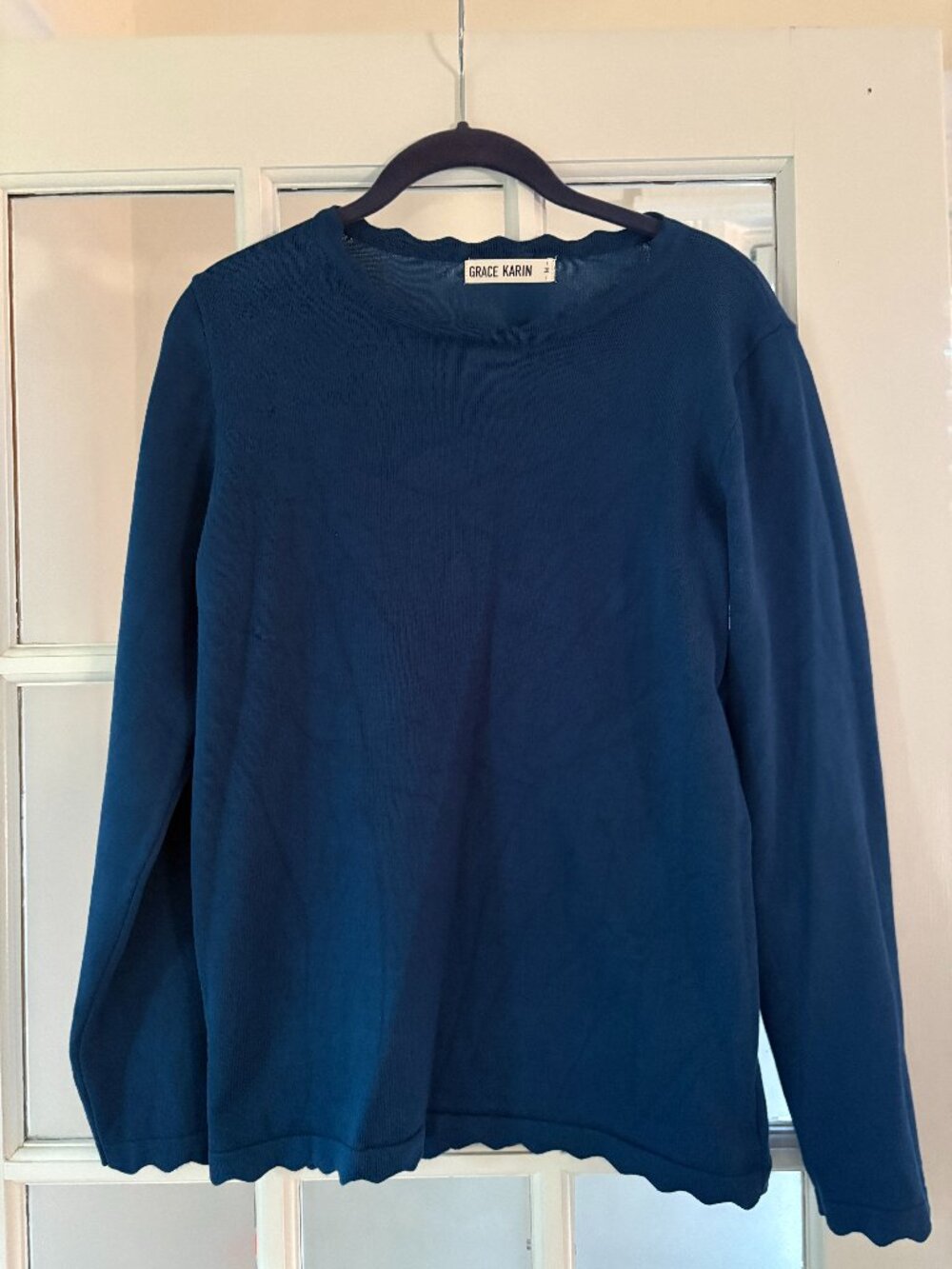 Blue long-sleeve shirt with scalloped edges